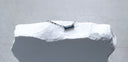 Bar None baguette sapphire necklace in 14K white gold displayed on a white textured stone block.